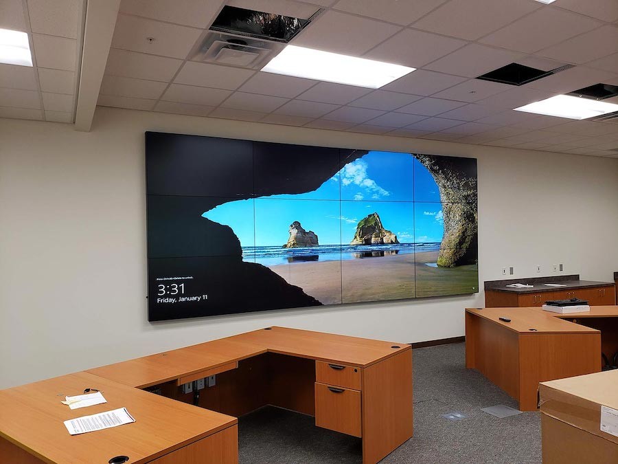 large video wall display mounted at the front of a training facility