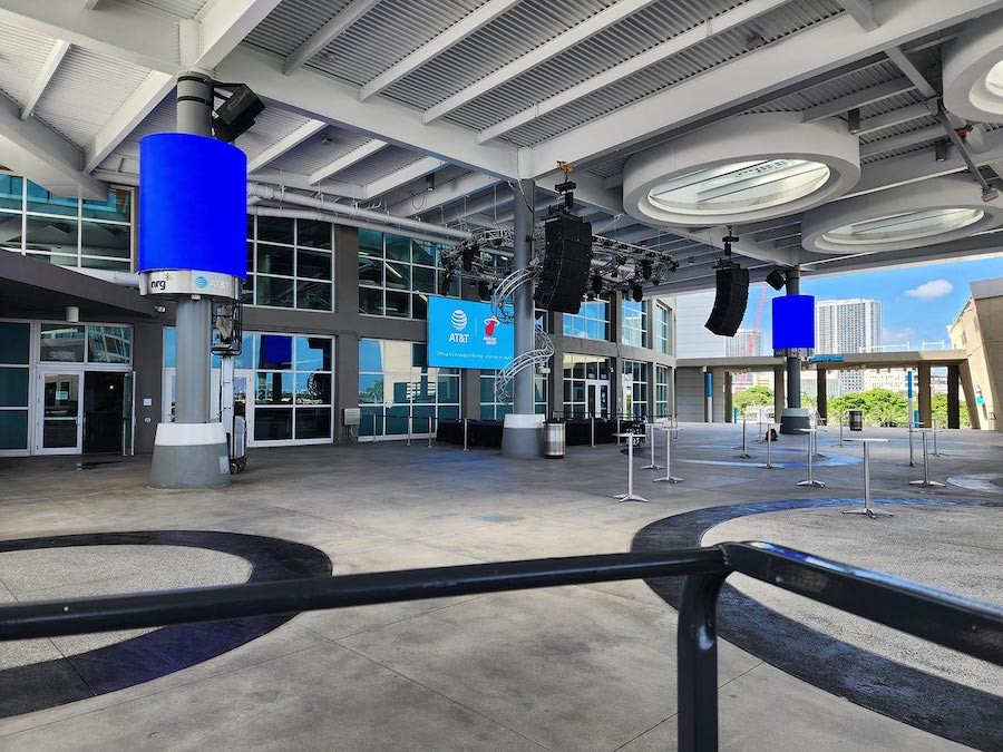 outdoor arena entrance with large LED digital signage mounted above the entry doors