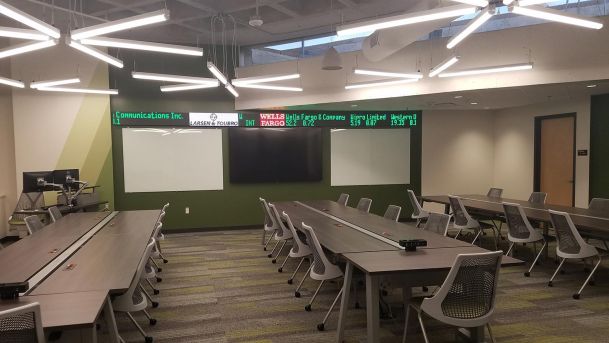 Training Room in grey colors and a green wall with 2 whiteboards and a TV