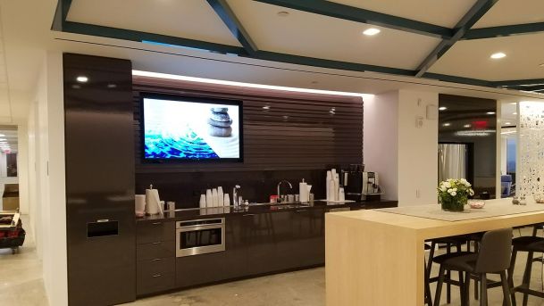 Office kitchen in brown and beige with a TV