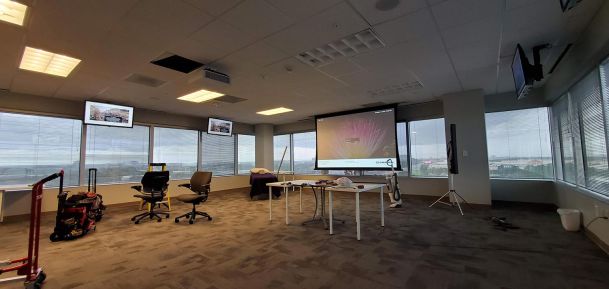 Screen and TVs in an empty office space